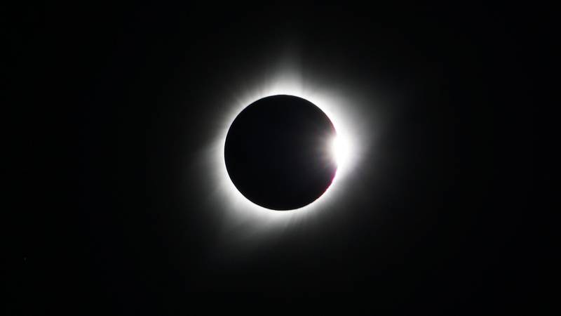 Sun being blocked by moon during eclipse.