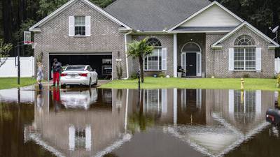 Tropical rains flood homes in an inland Georgia neighborhood for the second time since 2016