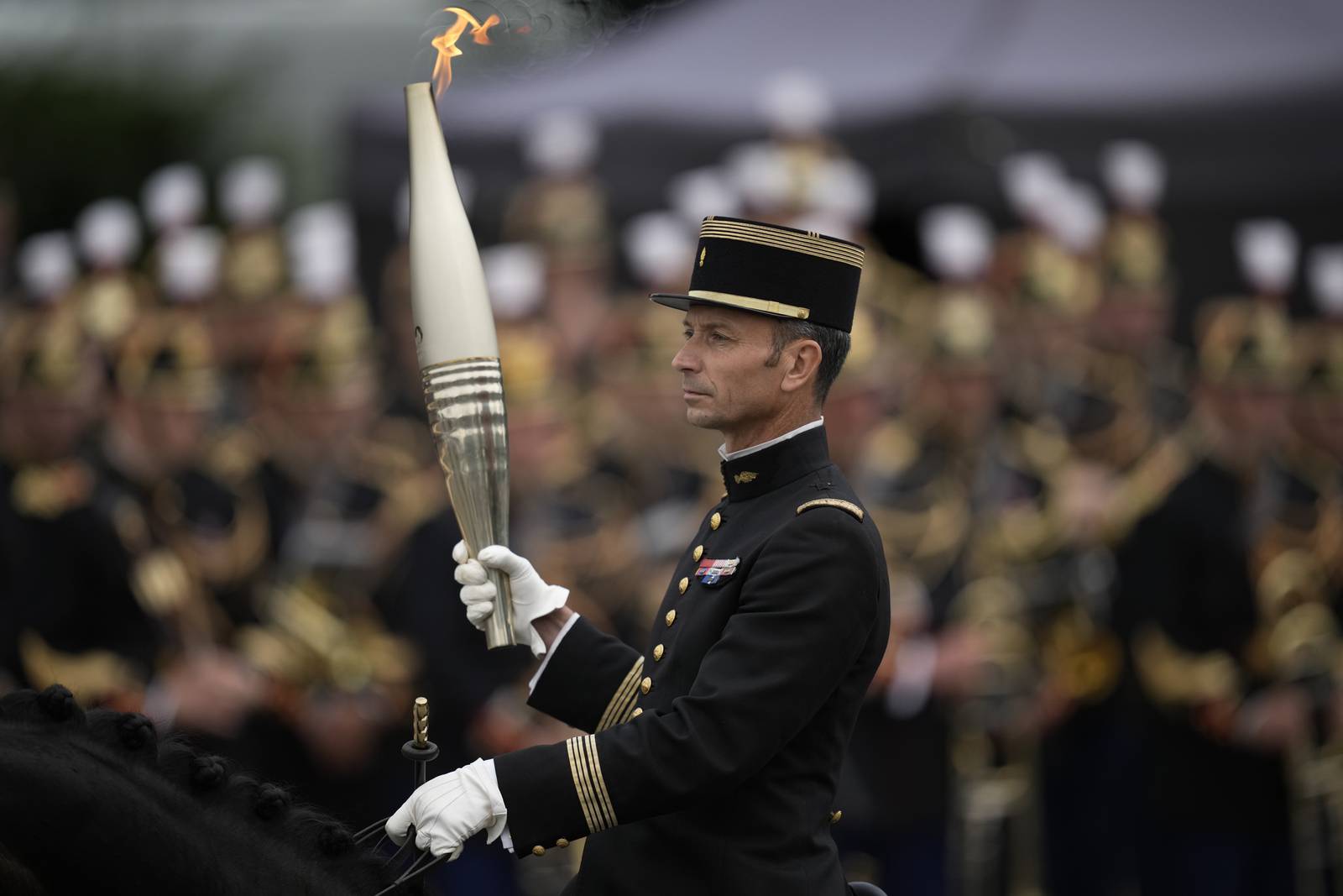 France's Bastille Day parade meets the Olympic torch relay in an