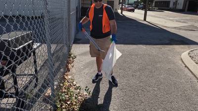Keep Orlando Beautiful volunteers clean up the railroad tracks in Downtown Orlando 