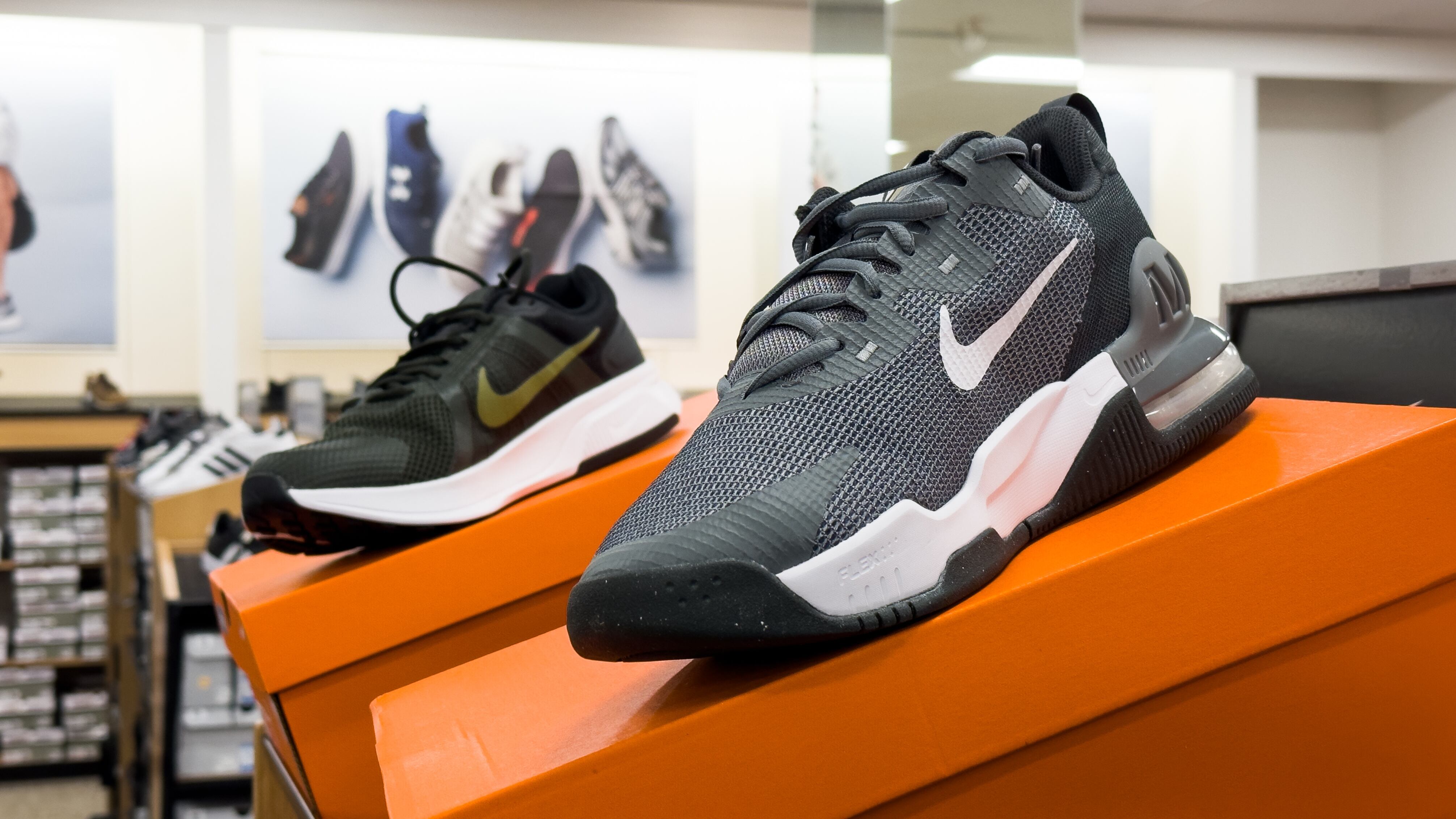 Nike sports shoe display on the store shelf.