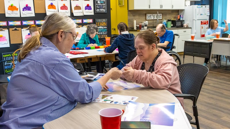 Adult residents at The Russell Home complete a project in class.