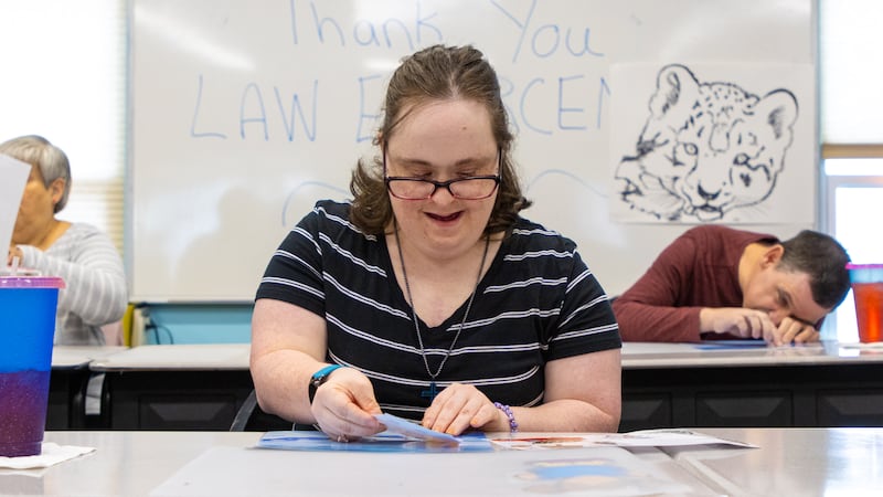 Adult residents at The Russell Home complete a project in class.