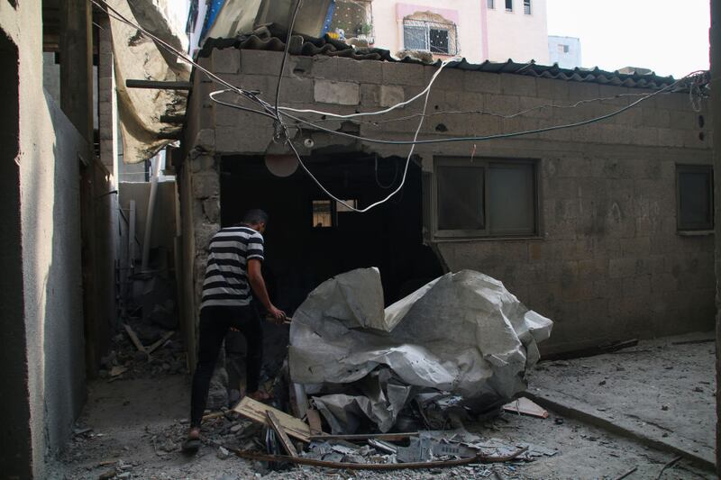 GAZA CITY, GAZA - OCTOBER 08: Palestinian citizens inspect damage to their homes caused by Israeli airstrikes on October 08, 2023 in Gaza City, Gaza. After the attack launched by Hamas on Israel yesterday, which surprised them, Israeli Prime Minister Benjamin Netanyahu asked the Palestinians to leave Gaza, and warned that the army would turn Hamas positions “into rubble.” (Photo by Ahmad Hasaballah/Getty Images)