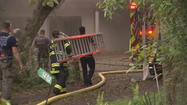 Firefighters rescue workers after attic insulation catches fire